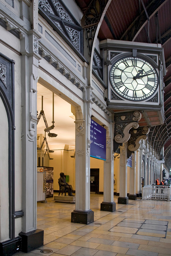 Station clock, platform 1, Paddington station 
 Looking more akin to a pulpit in a great cathedral the triple faced clock on Paddington's station platform one sits in a lofty position halfway along the platform. In the space below is the famous statue of the stations designed I.K Brunel sitting on a plinth admiring his railway cathedral so the pulpit comparison a little aerier seems to make sense! Just visible behind Brunel's statue is an information board about Crossrail. Apparently, whenever it opens, no way behind schedule, this point will be where passengers will access its platforms with the line running parallel to the station under Eastbourne Terrace. 
 Keywords: Station clock platform 1 Paddington station