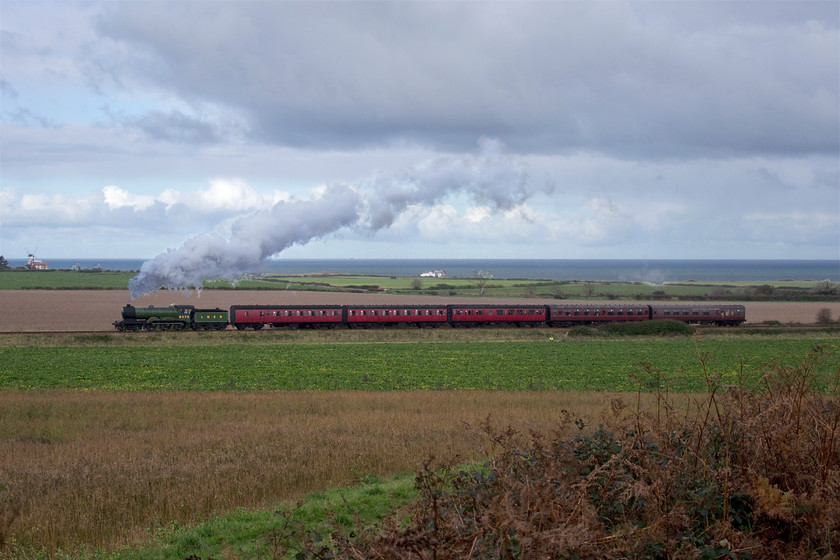 8572, 11.45 Sheringham-Holt, Weybourne Wood TG127424 
 During our walk, we watched the 11.45 Sheringham to Holt North Norfolk Railway service pass between us and the North Sea in the background on the edge of Weybourne Woods. The apple green painted ex LNER locomotive was the final example of the class to be withdrawn in 1961 some two years after the rest of the class had been taken out of service. It arrived at the fledgling North Norfolk Railway in 1967 and has been here ever since. As can be seen here it is yet another grey and cloudy day, a pattern of weather that characterised our week away - you can't win them all! 
 Keywords: 8572 11.45 Sheringham-Holt Weybourne Wood TG127424 B12 LNER