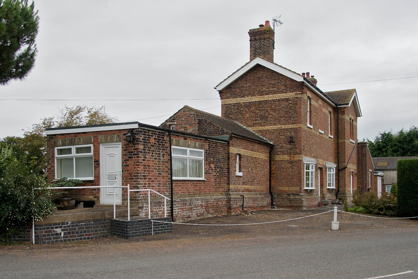 Postland station (Closed 11.09.61) 
 The rear of the former Postland station is seen located where the B1166 road crosses the former GN & GE Joint line between March and Spalding. The station closed, along with all others on the line apart from the already shut Murrow West on 11.09.61. The loss of local passenger services on the route was another advanced nail in its coffin with all through services, passenger and freight, withdrawn in 1982 when the line was finally shut. A relatively short stretch of line linking March and Spalding that today would have been an excellent freight route taking traffic off the busy ECML but hindsight is a marvellous thing! 
 Keywords: Postland station Closed 11.09.61