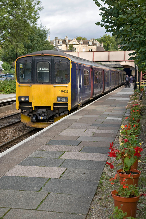 150926, GW 15.28 Warminster-Great Malvern (2E25), Bradford-on-Avon station 
 Just catching some late afternoon September sunshine 150926 pauses at Bradford-on-Avon station forming the 15.28 Warminster to Great Malvern train. I chose a portrait format for this image so as to include the lovely line of potted geraniums looked after by the friends of Bradford-on-Avon station team. From what I remember from my spotting days of the 1970s, the station is in much better condition now and certainly enjoys a far more regular service but as for the present motive the power I am not so sure! 
 Keywords: 150926 GW 15.28 Warminster-Great Malvern 2E25 Bradford-on-Avon station First Great Western