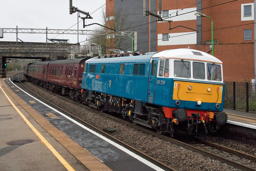 86259, outward leg of The Cumbrian Coast Express, 07.10 London Euston-Carlisle (1Z86), Wolverton station 
 Looking absolutely superb, as usual, 86259 'Les Ross/PeterPan' races through Wolverton station running some twenty minutes late with The Cumbrian Coast Express 1Z86 from Euston to Carlisle. As it was running late, control sensibly kept it on the down fast here rather than running it on the slow as far as Hanslope Junction to then switch it to the fast. On arrival at its destination, all lost time had been made up. The return leg was also unaffected by the extreme weather that affected many parts of Scotland and northern England on this day, despite its exposed route back south around the Cumbrian coast. 
 Keywords: 86259 The Cumbrian Coast Express 07.10 London Euston-Carlisle 1Z86 Wolverton station