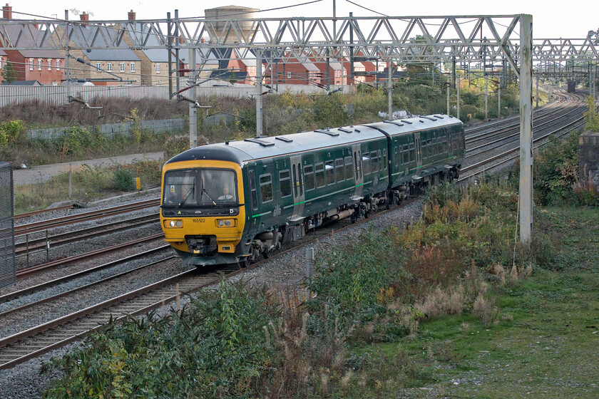 165122, 14.03 Wolverton Centre Sidings-Reading Traincare Depot (5Q71, 21E), site of Roade station 
 Following the delivery of 165123 earlier previously numbered 165122 heads back home to GWR metals via a rather strange route to Coventry (reversal), Leamington Spa and Oxford. Quite why it did not travel via London remains a mystery but at least it meant the odd scene of a GWR unit on the WCML running as 5Q71, 14.03 Wolverton to Reading. 
 Keywords: 165122 14.03 Wolverton Centre Sidings-Reading Traincare Depot 5Q71 site of Roade station Great Western Railway GWR