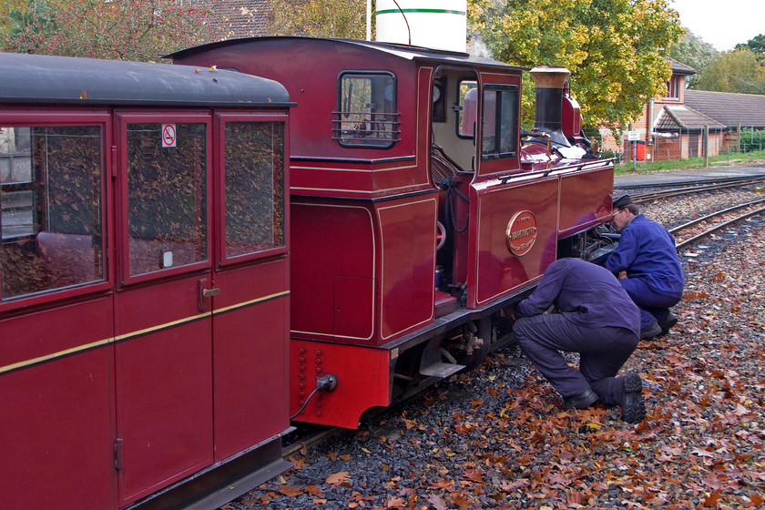 9, 12.40 Aylsham-Wroxham, Aylsham station 
 The crew undertake some basic servicing of 8 'Mark Timothy' prior to its departure with the 12.40 Aylesham to Wroxhm Bure Valley Railway service. My wife, son and I took this train to its destination some nine miles away from here at Aylesham. One of the coaches operated by the railway is seen in this photograph, small and compact they are comfortable and offer a reasonable ride despite running on 15" bogies. 
 Keywords: 9 12.40 Aylsham-Wroxham Aylsham station Bure Valley Railway Mark Timothy