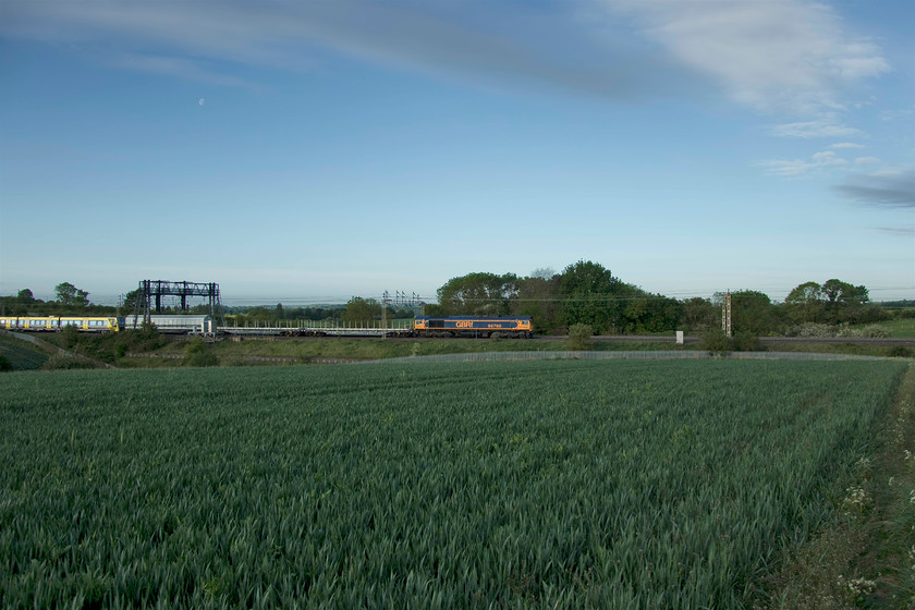 66768 & 777004, 02.44 Dollands Moor-Kirkdale Carriage sidings (6X29, 2L), between Roade & Ashton 
 66768 leads the 6X29 02.44 Dollands Moor to Kirkdale through the early morning Northamptonshire countryside just south of Roade. The GBRf Class 66 is leading three barrier wagons and then, just in shot, a new Merseyrail unit number 777004 that arrived on UK soil by travelling through the tunnel on its long journey from Switzerland. After standing in bright sunshine an errant cloud covered the sun just seconds before the train arrived taking the edge off the light. 
 Keywords: 66768 777004 02.44 Dollands Moor-Kirkdale Carriage sidings 6X29 between Roade & Ashton Merseyrail Stadler