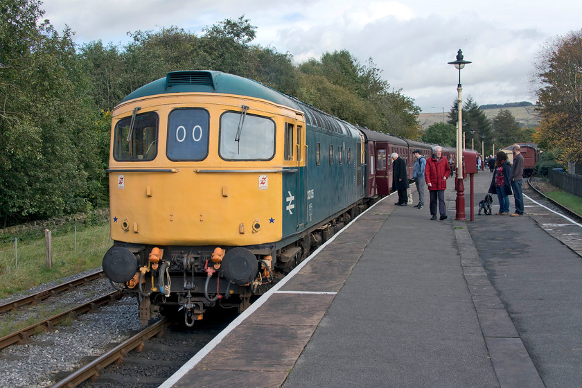 33035, 13.55 Rawtenstall-Heywood, Rawtenstall station 
 33035 has backed on to the stock ready to work the 13.55 to Heywood at Rawtenstall station. My wife and I took this train back to Bury where I stayed on to Heywood whilst she sampled the delights of Bury's shops! 330035 is a familiar locomotive to me from my formative railway years during the 1980s. It was a regular performer on Portsmouth Harbour to Bristol/Cardiff Central services and I have a particularly good picture of it climbing Upton Scudamore bank past Dilton Marsh in January 1984, the image will be uploaded to my site in the future! 
 Keywords: 33035 13.55 Rawtenstall-Heywood, Rawtenstall station