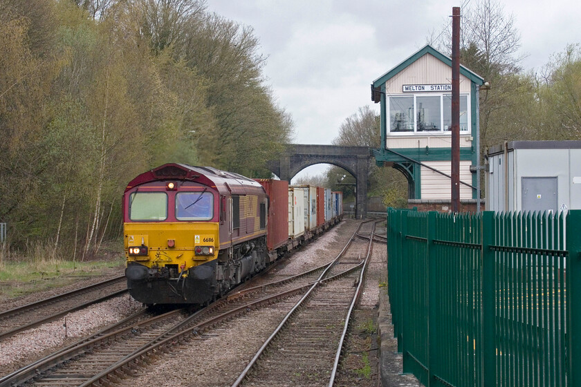 66116, 10.57 East Midlands Gateway-Felixstowe Central (4L38, 3E), Melton Mowbray station 
 66116 brings the 4L38 10.57 East Midlands Gateway to Felixstowe Freightliner service slowly past Melton Station signal box easing down in readiness for access to the long loop just beyond the station behind me. The reason for it being looped was that it was passing this spot an eye-watering sixty-five minutes early after leaving East Midlands Gateway nearly fifty minutes ahead of schedule. 
 Keywords: 66116 10.57 East Midlands Gateway-Felixstowe Central 4L38 Melton Mowbray station EWS Freightliner