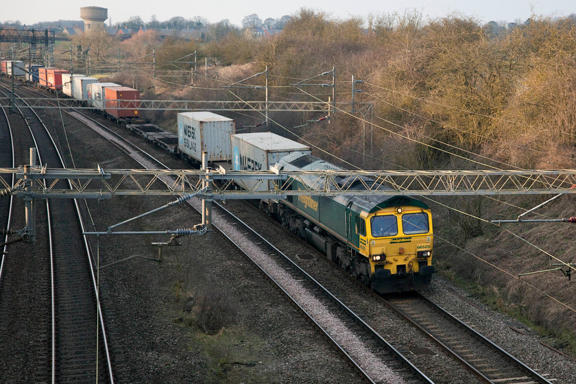 66520, 12.32 Crewe BH-Felixstowe N (4L90), Victoria Bridge 
 66520 leads the 4L90 12.32 Crewe basford hall to Felixstowe Freightliner past Victoria Bridge on the WCML just south of Roade in Northamptonshire. 
 Keywords: 66520 4L90 Victoria Bridge