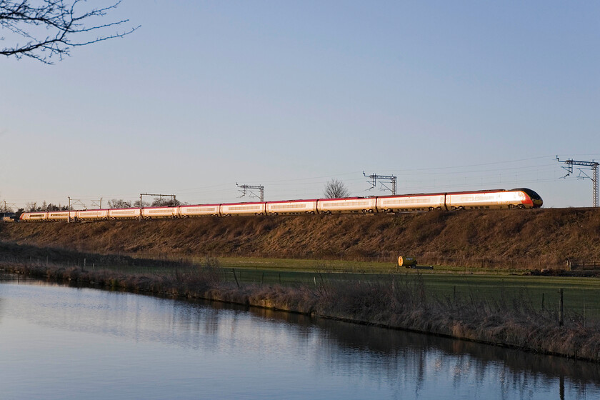 Class 390, VT 07.35 London Euston-Manchester Piccadilly, Whilton Locks SP619640 
 A 'glint shot' of and unidentified Class 390 as it approaches Whilton in Northamptonshire working the 07.35 Euston to Manchester service. Whilst I like the reflections in the still waters of the Grand Union Canal it's a shame that this does not extend to the train itself. 
 Keywords: Class 390 07.35 London Euston-Manchester Piccadilly Whilton Locks SP619640 Virgin West Coast Pendolino