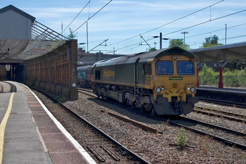 66553, running round, Crewe station 
 66553 brought a short infrastructure train in from Basford Hall bringing it to a halt just out of view of this photograph. It then detached from the train and is seen making its way away from the wagons to run round. It was interesting to note that the cab contained no fewer than five Freightliner staff members that must have made social distancing somewhat tricky! 
 Keywords: 66553 running round Crewe station Freightliner