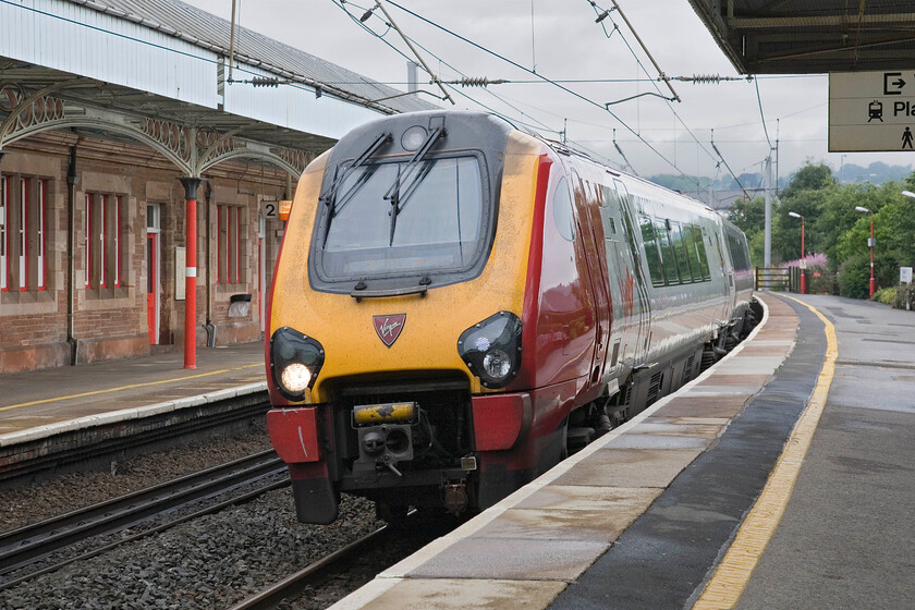 221117, VT 06.52 Edinburgh Waverley-Birmingham New Street, Penrith station 
 Arriving at Penrith station after an epic non-stop drive from Northamptonshire, the first train to greet us is a Virgin Voyager! 221117 slows for its stop, working the 06.52 Edinburgh to Birmingham New Street service. 
 Keywords: 221117 06.52 Edinburgh Waverley-Birmingham New Street Penrith station Virgin Voyager