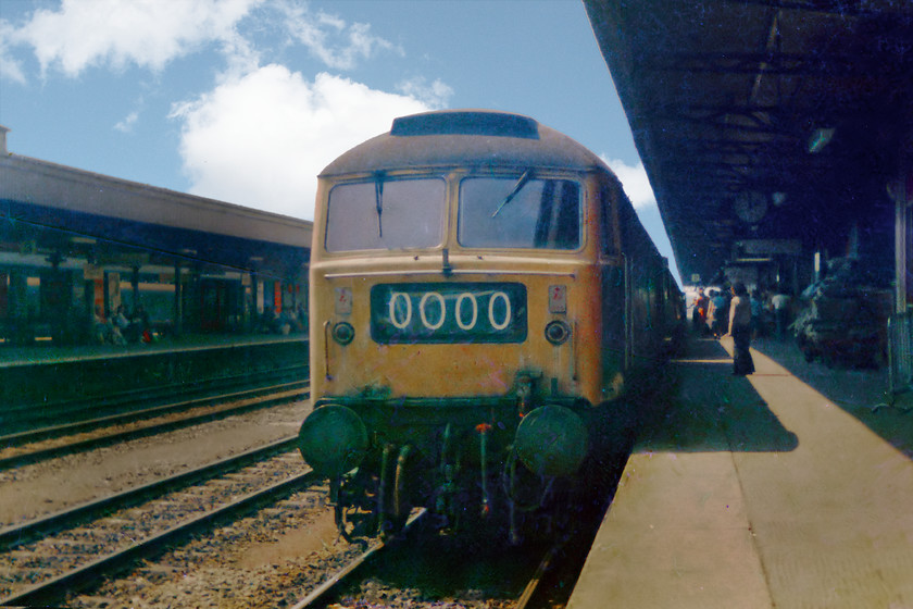 Class 47, unidentified up working, Cardiff Central station 
 An unidentified class 47 arrives in to Cardiff Central's number two platform with a train from the west. In this busy view, notice the loaded flat-bed parcels trolley and the clock reading two o'clock, perhaps this might be able to lead to an identification of the class 47 and the working? 
 Keywords: Class 47 Cardiff Central station