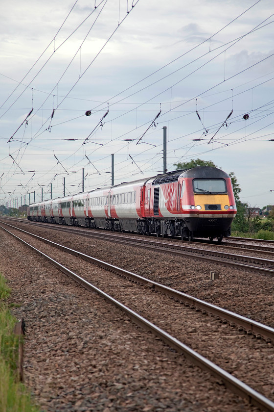 43307 & 43318, GR 10.03 London Kings Cross-Leeds (1D09, 2L), Holme Green Crossing TL192426 
 This picture illustrates the intensive use that these elderly HSTs are put to. An hour or so earlier, Andy and I saw this HST working south from Leeds. 43307 and 43318 work north again back to Leeds with the 10.03 from King's Cross. The train is seen at full line speed tearing past Holme Green farm crossing just south of Biggleswade. 
 Keywords: 43307 43318 1D09 Holme Green Crossing TL192426