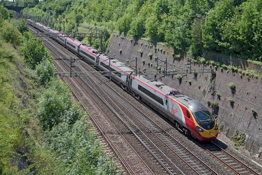 390156, VT 10.40 London Euston-Manchester Piccadilly (1H74), Roade Cutting 
 350156 'Stockport 170' passes northwards through Roade Cutting with the 10.40 Euston to Manchester Piccadilly. 35156 was the first of the eleven-car Pendolinos into service in April 2012. During the winter of 2013 it was named to commemorate the 170th anniversary of the opening of Stockport station. 
 Keywords: 390156 1H74 Roade Cutting