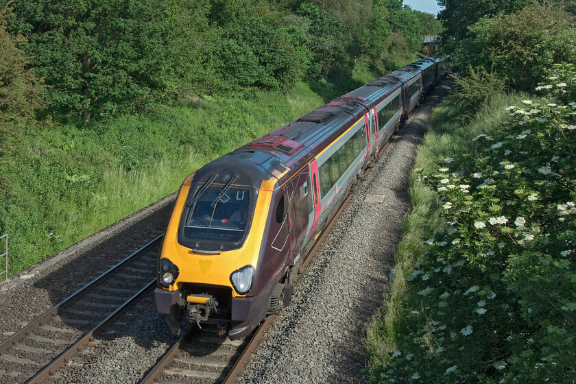 221141 & 221120, XC 05.11 Manchester Piccadilly-Bournemouth (1O04, 11L), King's Sutton 
 If this had been a single Voyager it would have just fitted in the space between the front and the greenery to the centre top right. Unfortunately, the 1O04 05.11 Manchester to Bournemouth CrossCountry service was composed of 221141 and 221120 with the latter just out of sight around the curve. The train is seen approaching King's Sutton just south of Banbury. Notice that the leading Voyager is suffering from the perennial problem of condensation filling the headlight. 
 Keywords: 221141 221120 05.11 Manchester Piccadilly-Bournemouth 1O04 King's Sutton CrossCountry Voyager