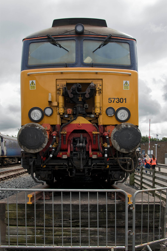 17. 57301, on-display, DRS Kingmoor 
 57301 sits at the top of the loading bay at DRS KIngmmor. The loading bay is used when locomotives need to arrive and depart from the depot via road with a lorry reversing to the raised section of track making the transfer easier. However, getting a low loader complete with a locomotive on-board away from the depot would be a tricky affair so I suspect that this facility is not used very often! 57301 was the first of the fabled Virgin Thunderbirds delivered during June 2002 and named 'Scott Tracy' having been converted from 47845. In a previous life, this locomotive was also numbered 47069 that I saw at a cold Bradford Junction in March 1979, see..... https://www.ontheupfast.com/v/photos/21936chg/26169671004/x47069-pines-express-07-48-london 
 Keywords: 57301 on-display DRS Kingmoor