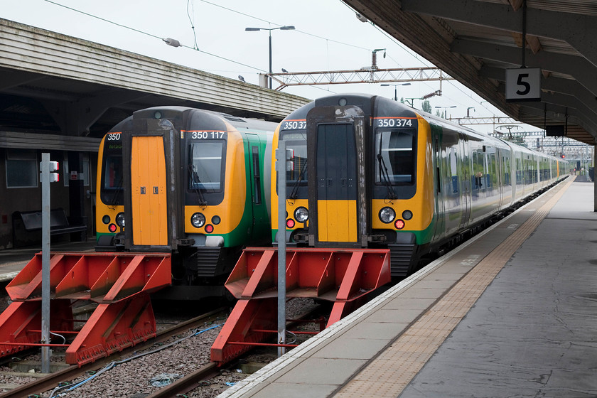 350117, LM 07.16 Northampton-Birmingham New Street (2Y57) & 350374, LM 07.37 Northampton-Birmingham New Street (2Y05), Northampton station 
 Two Birmingham New Street trains stand at Northampton's platforms four and five. To the left, 350117 will work the 07.17 to New Street whilst 350374 is at the back of the 07.37 service. These platforms were brought back into use about fifteen years ago having been closed for passenger use after their role as parcel platforms ended. 
 Keywords: 350117 07.16 Northampton-Birmingham New Street 2Y57 350374 07.37 Northampton-Birmingham New Street 2Y05 Northampton station