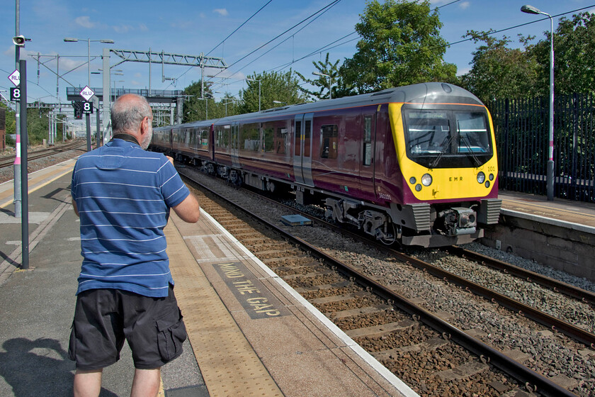 360101, EM 09.52 Kettering CS-Bedford Cauldwell Depot (5M05, 13E), Bedford station 
 Having taken his photograph, Andy watches 360101 slow for its passage through Bedford station as the 5M05 09.52 Kettering to Bedford depot empty stock working. Whilst the sidings at Kettering enable basic servicing to be undertaken they are really just carriage sidings with more substantial attention requiring the units to go to Cauldwell sidings as is the case here. 
 Keywords: 360101 09.52 Kettering CS-Bedford Cauldwell Depot 5M05 Bedford station EMR Desiro East Midlands Railway