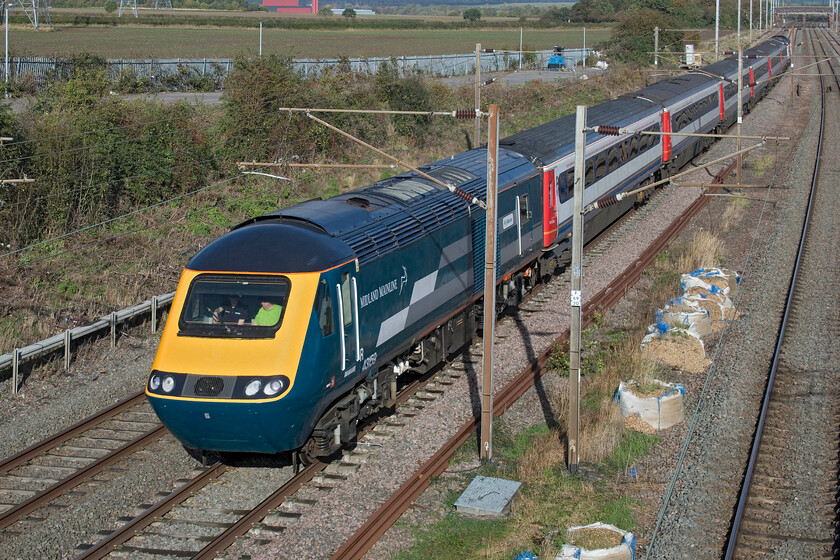 43159, outward leg of the Midland Venturer, 07.50 Ilkeston-London St Pancras (1Z43, 9L), Park Road bridge TL020390 
 The 125 Group's 43159 'Rio Warrior' looks superb in its retro. Midland Mainline livery in the brilliant autumnal sunshine between Bedford and Flitwick. I am sure that the group will get to the stock and repaint that to match the power car's livery as funds and time permit. The HST set, with 43159 at the rear, was working the outward leg of the Midland Venturer charter that left Ilkeston at 07.50 heading for St. Pancras. To the delight of enthusiasts is this the first time that a charter has started from this small Derbyshire town? As an aside, I do not believe that 43159 ever carried this livery being a Western Region power car for many years, for example, see....https://www.ontheupfast.com/p/21936chg/25853460404/x43159-43015-10-15-london-paddington 
 Keywords: 43159 the Midland Venturer 07.50 Ilkeston-London St Pancras 1Z43 Park Road bridge TL020390 Midland Mainline HST Project Rio Rio Warrier