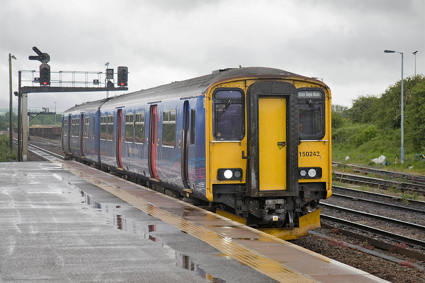 150243, GW 11.10 Weymouth-Bristol Temple Meads (2V90), Westbury station 
 The rain has eased off now at Westbury station but the light is still pretty ropey considering that it's the second day of flaming June! Sprinter 150243 arrives at the station with the 11.10 Weymouth to Westbury service. 
 Keywords: 150243 11.10 Weymouth-Bristol Temple Meads 2V90 Westbury station First Great Western Sprinter