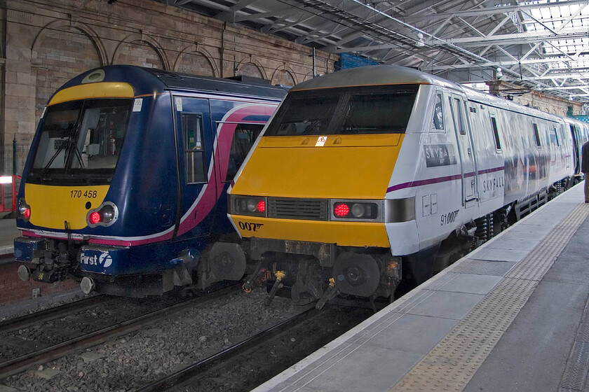 170458, SR 16.17 Newcraighall-Glenrothes & 91007 (91107), GR 17.00 Edinburgh Waverley-London King's Cross, Edinburgh Waverley station 
 170458 will soon depart from the depths of Edinburgh Waverley station with the 16.17 service to Glenrothes. Meanwhile, celebrity liveried, numbered and named 91107 'Skyfall' (now 91007) stands at the rear of the 17.00 departure to King's Cross. The Class 91 was named and unveiled a few weeks previously in a tie-up between East Coast and the promoters of the latest Bond film. 
 Keywords: 170458 16.17 Newcraighall-Glenrothes 91007 91107 17.00 Edinburgh Waverley-London King's Cross Edinburgh Waverley station