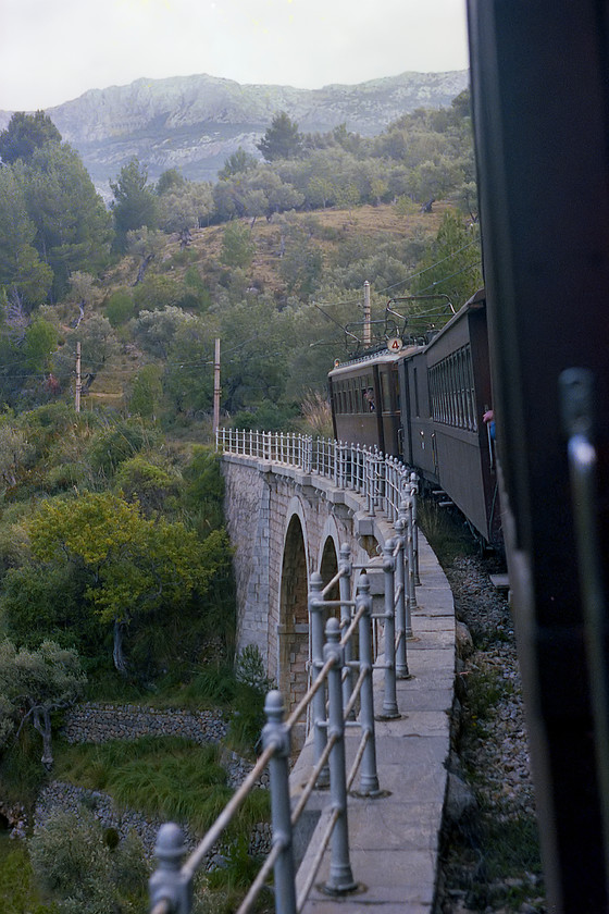 No. 4, unidentified Sller-Palma working, crossing Cinq cents viaduct 
 On our return journey from Sller to Palma we were hauled by locomotive no. 4. Here, the train is crossing the Cinq cents viaduct high in the Serra de Tramuntana mountains. 
 Keywords: No. 4 Sller-Palma working Cinq cents viaduct