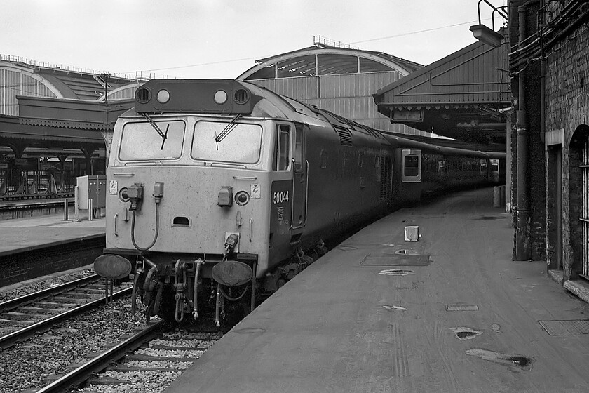 50044, 17.52 London Paddington-Westbury (1K68), London Paddington station 
 Our train home from London waits at Paddington's platform one. Having worked in from Oxford a little earlier no time was wasted, once the inbound stock was removed, to get 50044 'Exeter' away from the buffers and reversed back on to the stock of the 1K68. This train was often dubbed the 'Westbury Express' due to its tight timings and its stopping pattern. It was a heavily used commuter service that became popular with enthusiasts as well as the normals up to its demise in the mid-1990s. 
 Keywords: 50044 17.52 London Paddington-Westbury 1K68 17.52 London Paddington-Westbury London Paddington station Exeter