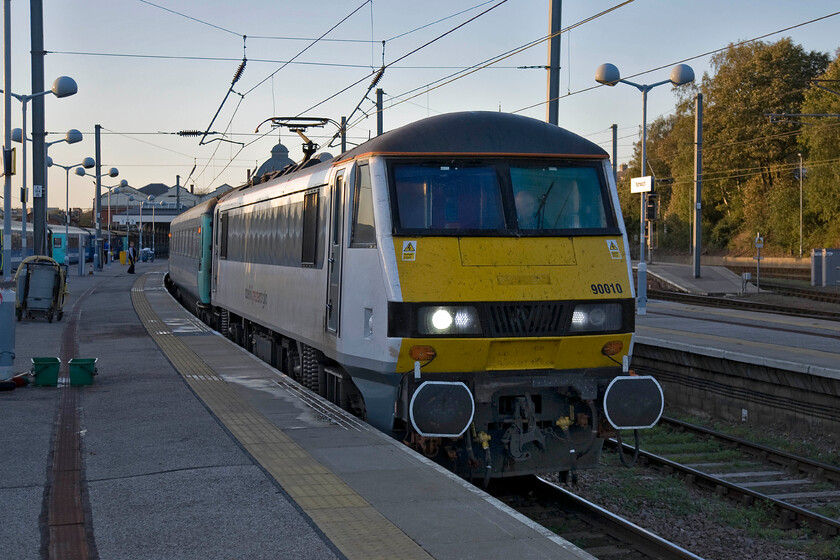 90010, LE 16.00 Norwich-London Liverpool Street (1P51), Norwich station 
 As the driver of 9001 gets the 16.00 to Liverpool Street away from Norwich he gives his windscreen a wash, despite that the platform staff will have done the same thing during the train's layover after arrival using the buckets and long washing brooms to the left. The light is lovely and soft now as the sun sets at the end of what has been a superb autumn day. 
 Keywords: 90010 16.00 Norwich-London Liverpool Street 1P51 Norwich station Abellio Greater Anglia