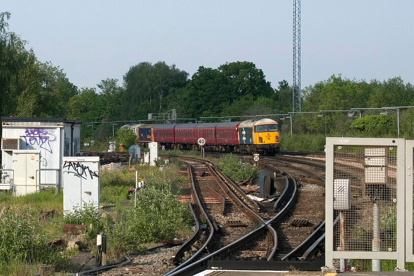 69002, 4TC set, 73109 & D6515, The Return of the Jurassic Crompton, 14.20 Swanage-London Waterloo (1Z35, 7L), Wimbledon station 
 Rapidly making up lost time from earlier in its journey the 1Z35 14.20 Swanage to Waterloo charter heads towards central London having passed through Wimbledon station on which I am standing. The interesting collection of stock and locomotives is headed by the partially obscured Crompton D6515 'Lt Jenny Lewis RN' followed by ED 73109 'Battle of Britain 50th Anniversary'. The stock is former 4TC set 413 with converted 56057 now 69002 'Bob Tiller CM&EE' bringing up the rear. I did not have time to wait for the return working that passed back this way after spending a very short time at Waterloo. 
 Keywords: 69002 4TC set 73109 D6515 The Return of the Jurassic Crompton 14.20 Swanage-London Waterloo 1Z35 Wimbledon station Lt Jenny Lewis RN Battle of Britain 50th Anniversary Bob Tiller CM&EE.