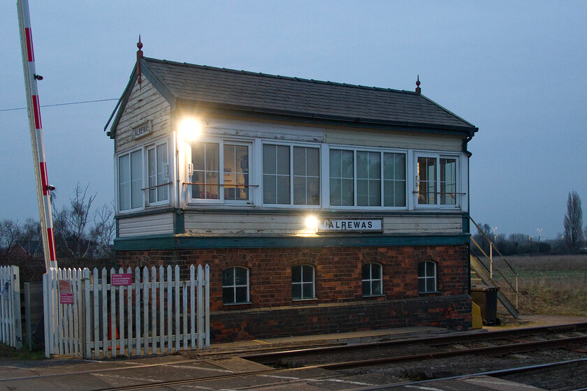 Alrewas signal box (LNW, 1899) 
 I last visited Alrewas in 2014, see..... https://www.ontheupfast.com/p/21936chg/30015978864/alrewas-signal-box. Then it was hot and sunny summer's day rather than a dismal February evening as is the case today! The fine LNWR box dates from 1899 and controls the short section of track that links the WCML at Litchfield TV with the Midland route at Wichnor Junction. We were invited into the box by the signalman and he explained that since my last visit in 2014, traffic had increased particularly at night with CrossCountry Voyagers traversing the route as empty stock heading to and from their large maintenance facility at the Central Rivers depot. He also said that he enjoyed working this box due to its quiet location despite being fairly close to the A38 dual carriageway that runs behind the trees in the background. 
 Keywords: Alrewas signal box LNWR 1899 London Northwestern Railway