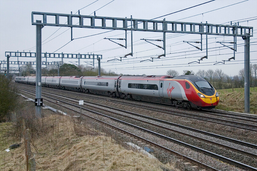 390009, VT 07.20 London Euston-Wolverhampton, Ashton Road bridge 
 390009 works the 07.20 Euston to Wolverhampton Virgin service nearing Roade in Northamptonshire on this dull and grey February morning. At least it's just a short walk home from here for a cup of tea and breakfast! 
 Keywords: 390009 07.20 London Euston-Wolverhampton Ashton Road bridge