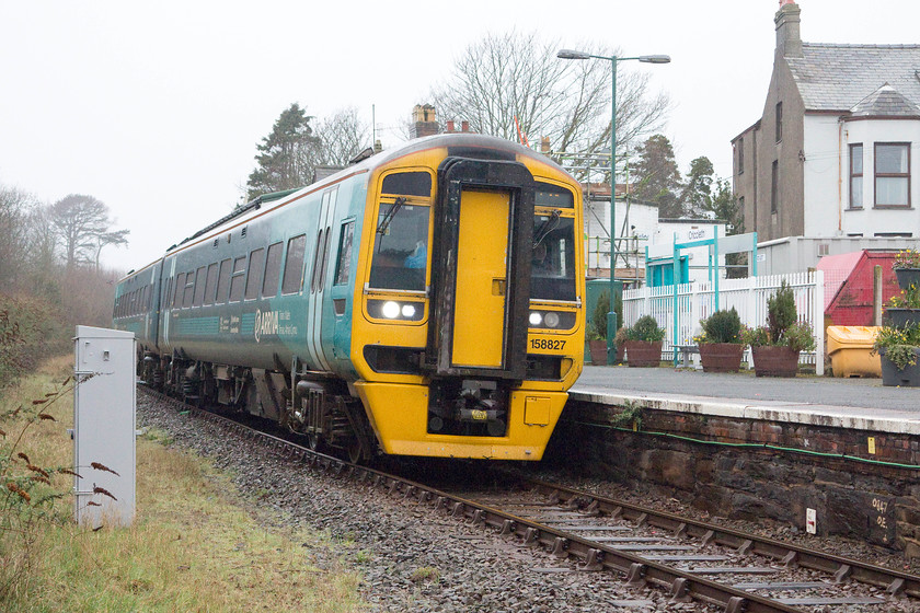 158827, AW 13.38 Pwllheli-Machynlleth & Birmingham International (2G55 & 1G55), Criccieth station 
 Criccieth is a small seaside town on the southern coast of the Llyn Peninsula. It is served by the small station seen in the background of this image that used to have another platfrom on the left that remained in place until signalling rationalisation caused its closure in 1977. 158827 arrives at the request stop with the 13.38 Pwllheli to Birmingham International. 
 Keywords: 158827, AW 13.38 Pwllheli-Machynlleth & Birmingham International (2G55 & 1G55), Criccieth station