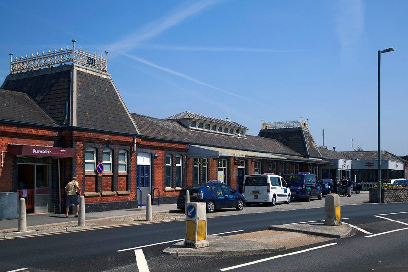 Frontage, Truro Station 
 This is a shot I am replicating from my previous visit to Truro in 1984. Then, the taxi waiting outside was a Renault 11 rather than a Toyota Prius, apart from that, the scene is essentially the same. The station shown here was rebuilt in 1897 replacing the previous one built during the broad gauge era and one that had an overall roof. Since 2011, Truro has the unfortunate accolade as being the only Cornish station to have a gate line with barriers, and boy, didn't the staff run it by the book! We were not allowed on the platform even after several polite attempts at asking. We were told that the station was too busy and it was a H & S issue; poppycock! I gave up in disgust but Andy did gain access after the supervisor disappeared and a more understanding member of staff relented. I raised this with Great Western Railway (along with two other issues encountered on our trip) on our return and they issued an apology and a travel voucher. 
 Keywords: Frontage Truro Station