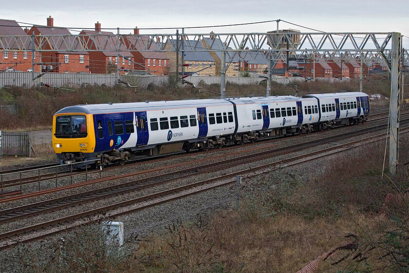 323210, 15.33 Wolverton Centre Sidings-Allerton Depot (5N36, 20E), site of Roade station 
 The driver will have worked the inbound unit from Liverpool a little earlier and is now heading back at the controls of 323210. The unit arrived at Wolverton Works back on the shortest day in December, see.... https://www.ontheupfast.com/p/21936chg/30063847949/x323210-08-41-allerton-depot-wolverton and is now emerging in its smart Northern livery ready for service in the North West. Running as 5N36 the unit left a little early arriving at Allerton Depot twenty minutes ahead of schedule. 
 Keywords: 323210 15.33 Wolverton Centre Sidings-Allerton Depot 5N36 site of Roade station Northern