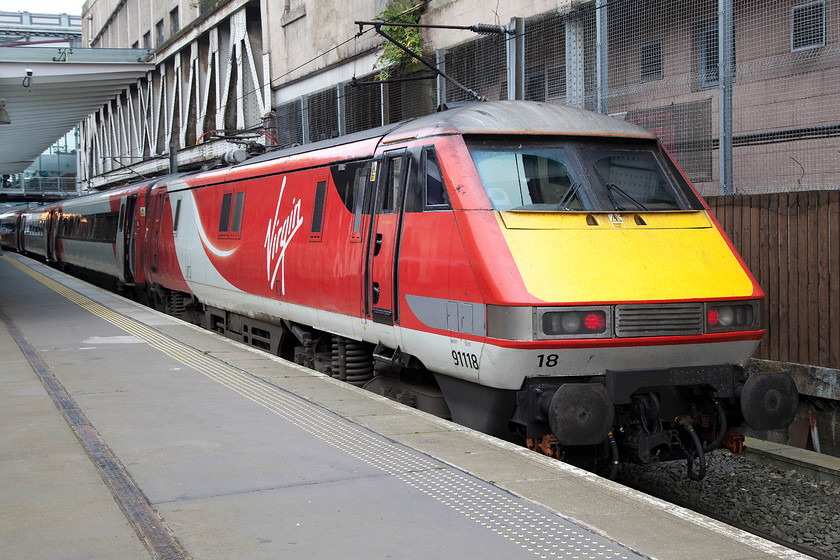 91118, GR 10.30 Edinburgh Waverley-London King`s Cross (1E11), Edinburgh Waverley station 
 91118 waits at the rear of the 10.30 to London King's Cross. I will miss these fine an powerfill electric locomotives when they are replaced in three of four years time by the new IETs that are to be introduced. It's a shame that the new trains have been designed and are being built abroad (initially at first until production moves to the UK under licence) unlike the class 91s that were built by BREL at Crewe in the late 1980s. 
 Keywords: 91118 10.30 Edinburgh Waverley-London King`s Cross 1E11 Edinburgh Waverley station