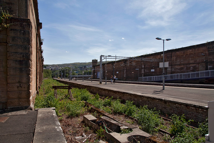 Greenock Central station 
 Greenock Central station is a shadow of its former self. Whilst the walls stand and the up and down platforms are in use, the rest has gone! Even, the footbridge was recently removed and to cross platforms necessitates a long walk up to Terr Road, across the railway and then back down again. 
 Keywords: Greenock Central station