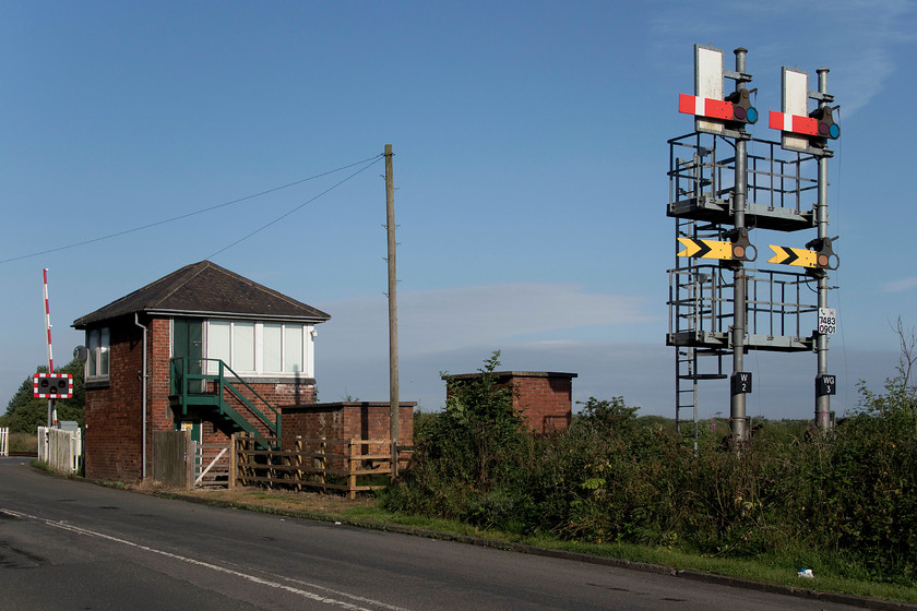 Winning signal box (NE, 1895) 
 The North Eastern Railway designed Winning signal box, dating from 1895, is seen in the early morning sunshine complete with an impressive, if modern designed, bracket signal that controls Winning Junction. Notice the strange shape and orientation of the two sighting boards The level crossing now has barriers but up until 2011 it had wooden boom gates, the number of which still remain, largely confined to the northeast, are very few. The branch line leading from Winning terminates at the Alcan alumina facility at North Blyth. It also saw very infrequent trains to and from Battleship Wharf and, until closure in 2001, a lot of coal traffic to and from the North Byth power stations. 
 Keywords: Winning signal box