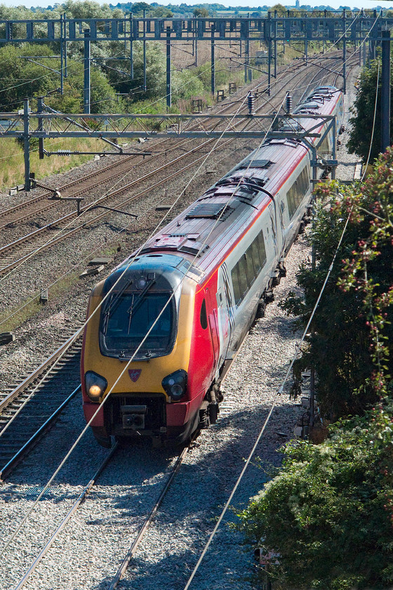 Class 221, VT 12.43 London Euston-Edinburgh Waverley (9S70), passing the TSR, Ashton Road bridge 
 A look at the metadata for this image would see that the shutter speed used was only 1/400th sec. This would normally result in a very blurred image at this location on Ashton Road bridge just south of Roade on the WCML. However, due to the fresh ballast lad the previous night, there was a walking pace temporary speed restriction in operation. A class 221 is seen forming the 9S70 12.43 Euston to Edinburgh. 
 Keywords: Class 221 12.43 London Euston-Edinburgh Waverley 9S70 passing the TSR, Ashton Road bridge