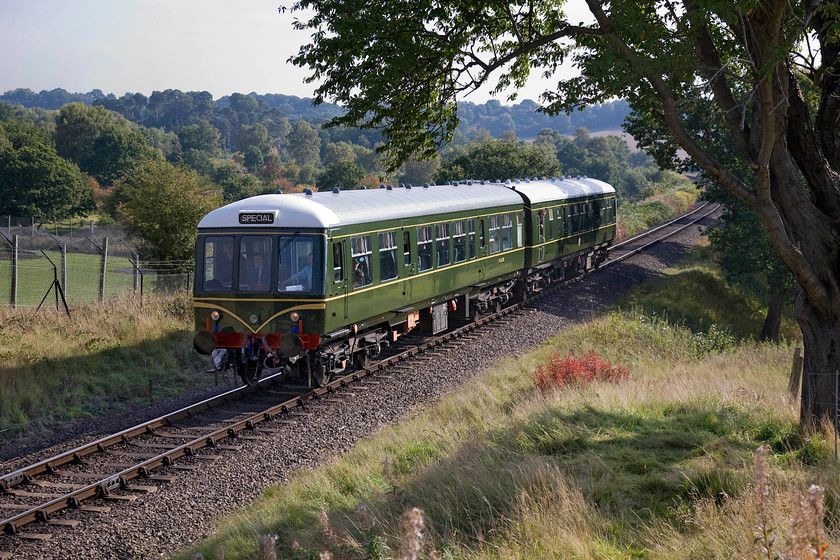 M56208 & M50933, 11.40 Kidderminster-Bewdley, West Midlands Safari Park SO799748 
 On a very pleasant and warm morning, the SVR's diesel gala is in full swing on its opening Friday. Patronage seemed healthy with the trains I observed passing being well loaded with enthusiasts eager to take in some heritage haulage. This spot is adjacent to the West Midlands Safari Park, the security fences of which can be seen to the left of this photograph. The 11.40 Kidderminster to Bewdley shuttle is being worked by a Class 108 DMU made up of M56208 and M50933. The DMU Group West Midlands, who own the units, is based on the SVR and has a very informative website giving plenty of information about their stock and operations, see.... https://www.svr-dmu.org.uk/ 
 Keywords: M56208 M50933 11.40 Kidderminster-Bewdley West Midlands Safari Park SO799748 Class 108 DMU