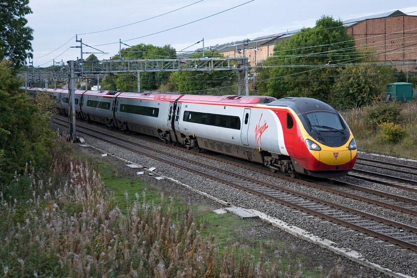 390010, VT 12.40 Glasgow Central-London Euston, Roade 
 390010 passes Roade working the afternoon 12.40 Glasgow to Euston Pendolino service. I am standing on the remains of the former Stratford-upon-Avon and Midland Junction Railway (SMJR) embankment at the point where it used to cross the WCML. 
 Keywords: 390010 12.40 Glasgow Central-London Euston Roade Virgin West Coast Pendolino