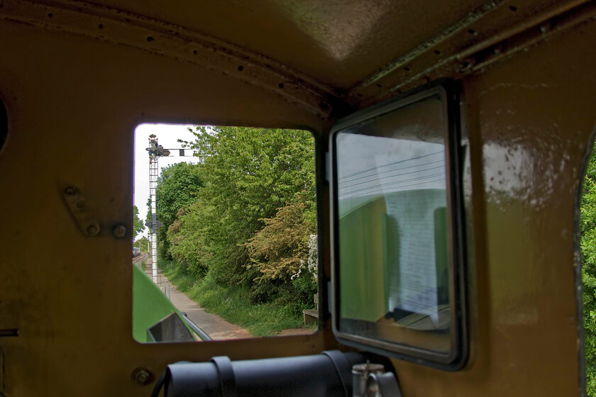 View from cab of No. 4, 12.00 Pitsford return 
 The view from the cab of 0-4-0 Peckett number 4 (2104) as it leaves Pitsford and Brampton station with the 12.00 return working. Taking a framed photograph such as this (or any others for that matter) was quite a challenge as the ride on the footplate of the locomotive could well be described as lively! 
 Keywords: View from cab of No. 4 12.00 Pitsford return