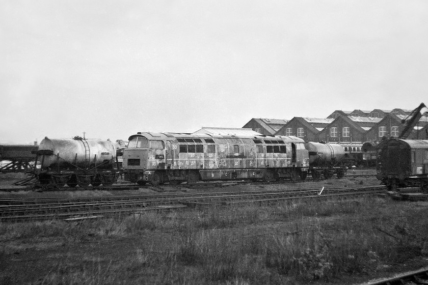 D1015, awaiting restoration, Swindon Works 
 Amongst the detritus in the huge scrappage area to the western end of Swindon works D1015 'Western Champion' is seen in virtually complete condition. I have established that the strange lines and numbers painted on its side were not a precursor to it being cut-up but were, in fact, part of an exercise for the trainees in the paint shop. D1015 lived on, now being in the care of the DTG (Diesel Traction Group) and can be seen both on the mainline as well as doing the rounds on the heritage lines attending their diesel galas. For example ....... https://www.ontheupfast.com/p/21936chg/29262545804/d1015-13-54-bewdley-kidderminster 
 Keywords: D1015 Western Champion awaiting restoration Swindon Works