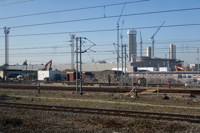 Demolition, Old Oak Common depot 
 Demolition is well under way of the last section of Old Oak Common depot that closed in 2018 when HST maintenance was removed from the site. There will be a huge interchange station at about the point where this picture is taken that will link the GWML, Crossrail and HS2. HS2 will then dive back under West London at the point about where the left hand excavator is and emerge some miles away in West Ruislip. 
 Keywords: Demolition Old Oak Common depot