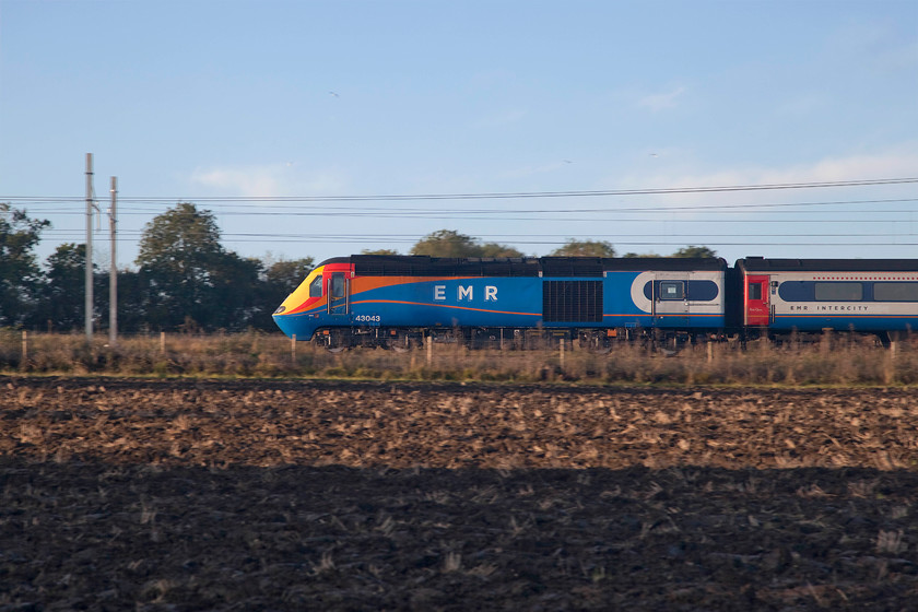 43043, EM 07.45 Nottingham-London St. Pancras (1B18, 5L), Wymington SP958633 
 With its new 'large logo' EMR lettering on the side, 43043 is the lead power car of the 07.45 Nottingham to St. Pancras. 43043 is one of the original batch of HSTs delivered to the West Country in 1976 as part of set 253021. Here it is over forty years' later still earning its keep on front line service! The train is seen ascending Sharbrook bank past the village of Wymington. 
 Keywords: 43043 07.45 Nottingham-London St. Pancras 1B18 Wymington SP958633