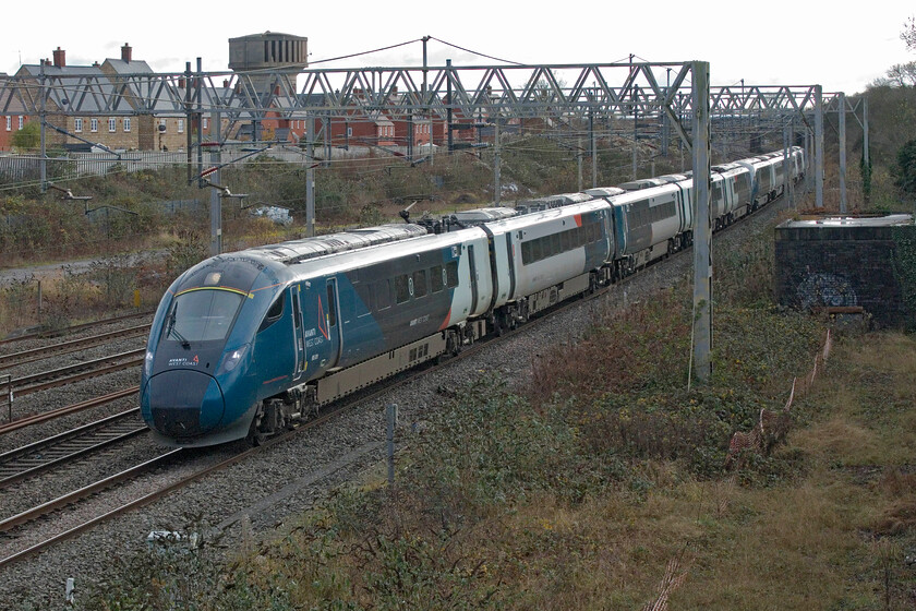 805009 & 805004, VT 10.02 London Euston-Chester (1D84, 11L), site of Roade station 
 With all the Class 805s now in service, a process that has taken six months, they are now a regular fixture on the WCML. 805009 and 805004 pass Roade working the 10.02 Euston to Chester service. I am still not convinced of the merits of coupling two sets together with no interconnection meaning double manning, can somebody explain the economics and practicalities of this, please? 
 Keywords: 805009 805004 10.02 London Euston-Chester 1D84 site of Roade station Avanti West Coast Evero