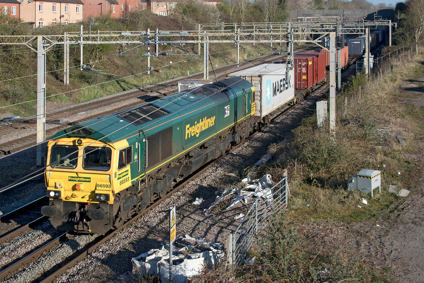 66593, 03.25 Garston-London Gateway (4L52, 3L), site of Roade station 
 After completing its long and steady climb from Northampton 66593 '3MG Mersey Multimodal Gateway' bursts into the early morning sunshine at Roade and can now pick up a little speed as it heads south. It is leading the 4L52 03.25 Garston to London Gateway Freightliner service. 
 Keywords: 66593 03.25 Garston-London Gateway 4L52 site of Roade station Freightliner 3MG Mersey Multimodal Gateway