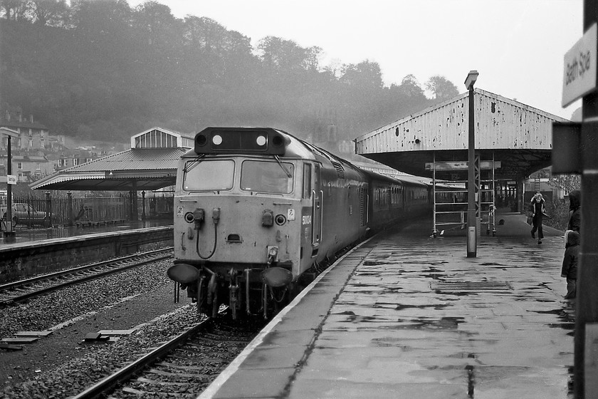 50034, unidentified up working, Bath Spa station 
 Despite HSTs, in theory, at least, handing all of the Paddington to Bristol and South Wales services by this time there were occasions when one was not available and a scratch set of stock and locomotive had to be mustered to work a train. This appears to be the case here as 50035 'Furious' stands at Bath Spa with an unidentified up working. As can be seen, the young spotter to the right was obviously quite excited as he runs along the platform to observe the event! 
 Keywords: 50034 up working Bath Spa station Furious