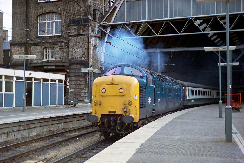 55017, 15.00 London Kings Cross-Newcastle (1N18), London Kings Cross station 
 55017 'The Durham Light Infantry' looks to be running on both engines as it leaves King's Cross. I have this down in my notes as the 1N18 15.00 to Newcastle. However, I think that this is incorrect as it's the next image on the negative strip after 55002 that worked the 15.00 to Edinburgh according to the Chronicles of Napier website, any information to solve this mystery gratefully appreciated. 55017 was one of my favourite Deltics as it was the first one I ever saw as a spotter in 1977 at York. In this image, notice the BR (Eastern Region) blue enamel above the portacabin to the far left. The cabin has now gone (along with the enamel) and the entrance is where the track for platform 0 goes into the station. 
 Keywords: 55017 15.00 London Kings Cross-Newcastle 1N18 London Kings Cross station