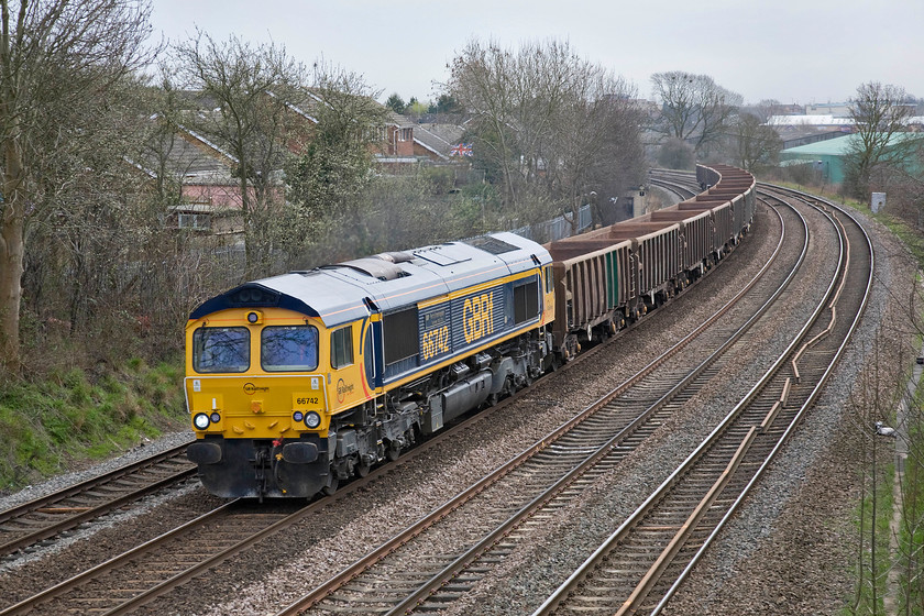 66742, 11.28 Wellingborough-Mountsorell (6D02), Kettering Headlands bridge SP864771 
 GBRf's 66742 'ABP Port of Immingham Centenary 1912-2012' leads the 6D02 11.28 Wellingborough to Mountsorrel empty stone train on the approach to Kettering taken from a small bridge at the end of Headlands Road. This relatively short turn will collect stone from Mountsorrel just north of Leicester and convey it to the virtual quarry in Wellingborough's Finedon Road yard. From here it is then taken off to various Network Rail infrastructure worksites. 
 Keywords: 66742 11.28 Wellingborough-Mountsorell 6D02 Kettering Headlands bridge SP864771 ABP Port of Immingham Centenary 1912-2012 GBRf GB Railfreight