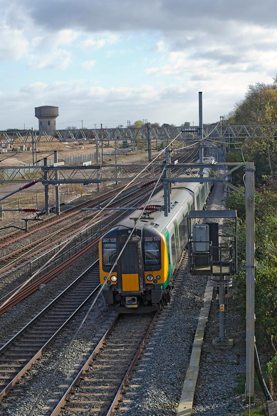 350125, LM 11.46 London Euston-Crewe (1U33), site of Roade station 
 Not the best composed picture taken of 350125 passing the site of Roade's old station but I wanted to show the extent of the clearance of the old Pianofort factory site that is nearing completion. Over the coming few years it will morph into a vast housing estate adding dramatically not only to Roade's population but also stretching its infrastructure to the limit. 
 Keywords: 350125 11.46 London Euston-Crewe 1U33 site of Roade station