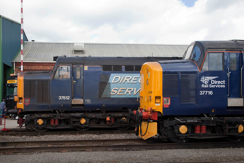 37612 & 37716, on-display, DRS Gresty Bridge 
 Two different versions of DRS's livery on-display at Gresty Bridge. At the back is 37612 looking fairly tired in the original DRS livery. In the foreground is 37716 wearing its new compass DRS styling. 
 Keywords: 37612 37716 DRS Gresty Bridge